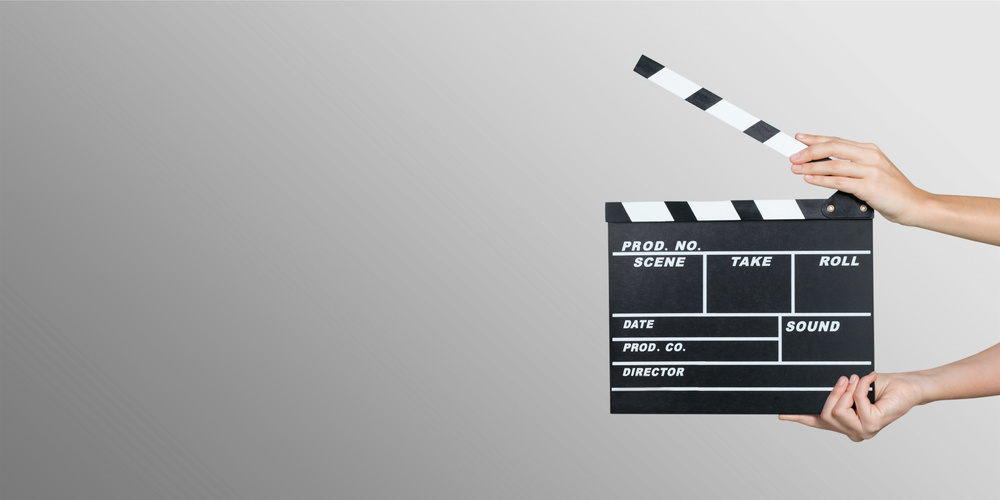 Hands Holding Clapper Board